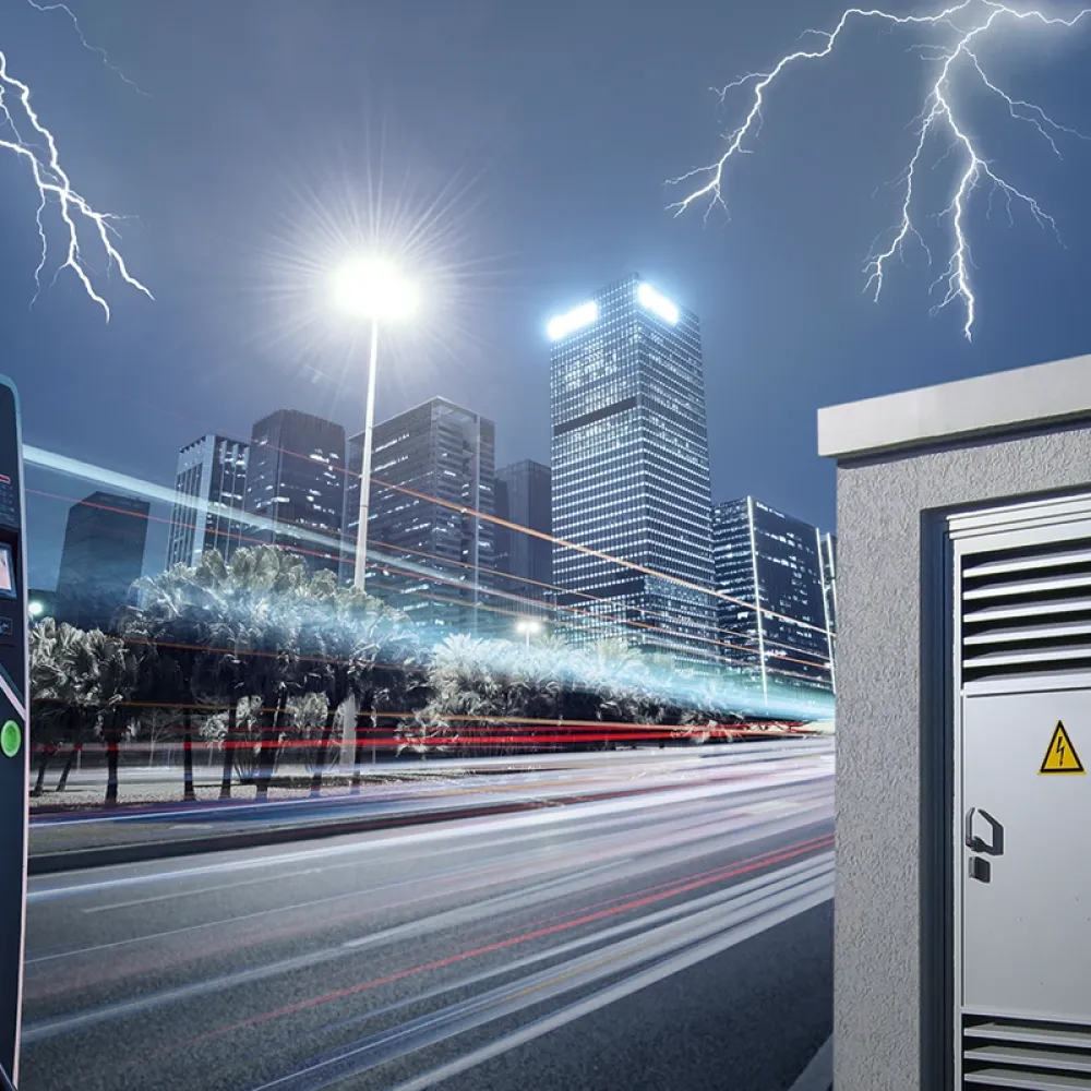 Electric vehicle charging station and power cabinet in an urban setting at night, with lightning over a city skyline.